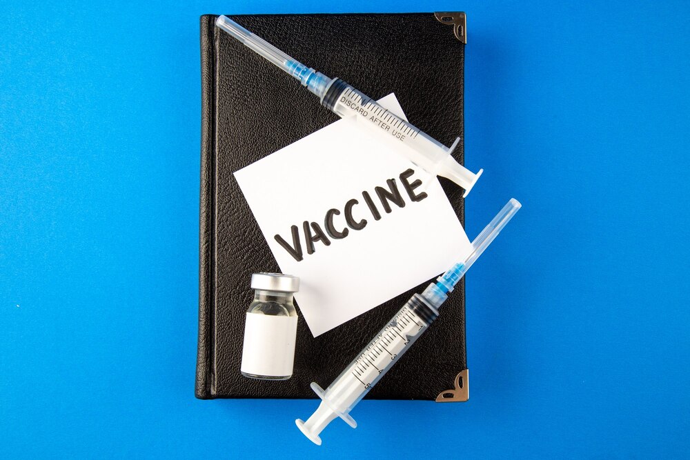 top view antivirus injections with copybook and vaccine on blue surface virus medicine hospital drug covid- lab cure health