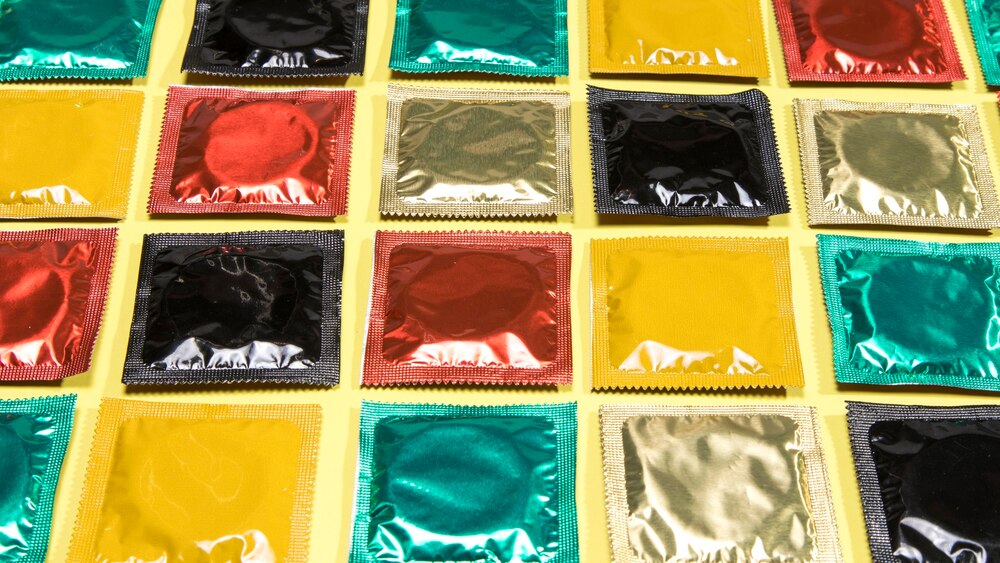 High angle different coloured wrapped condoms